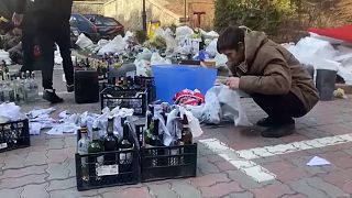 Ukrainians in Kyiv prepare Molotov cocktails 